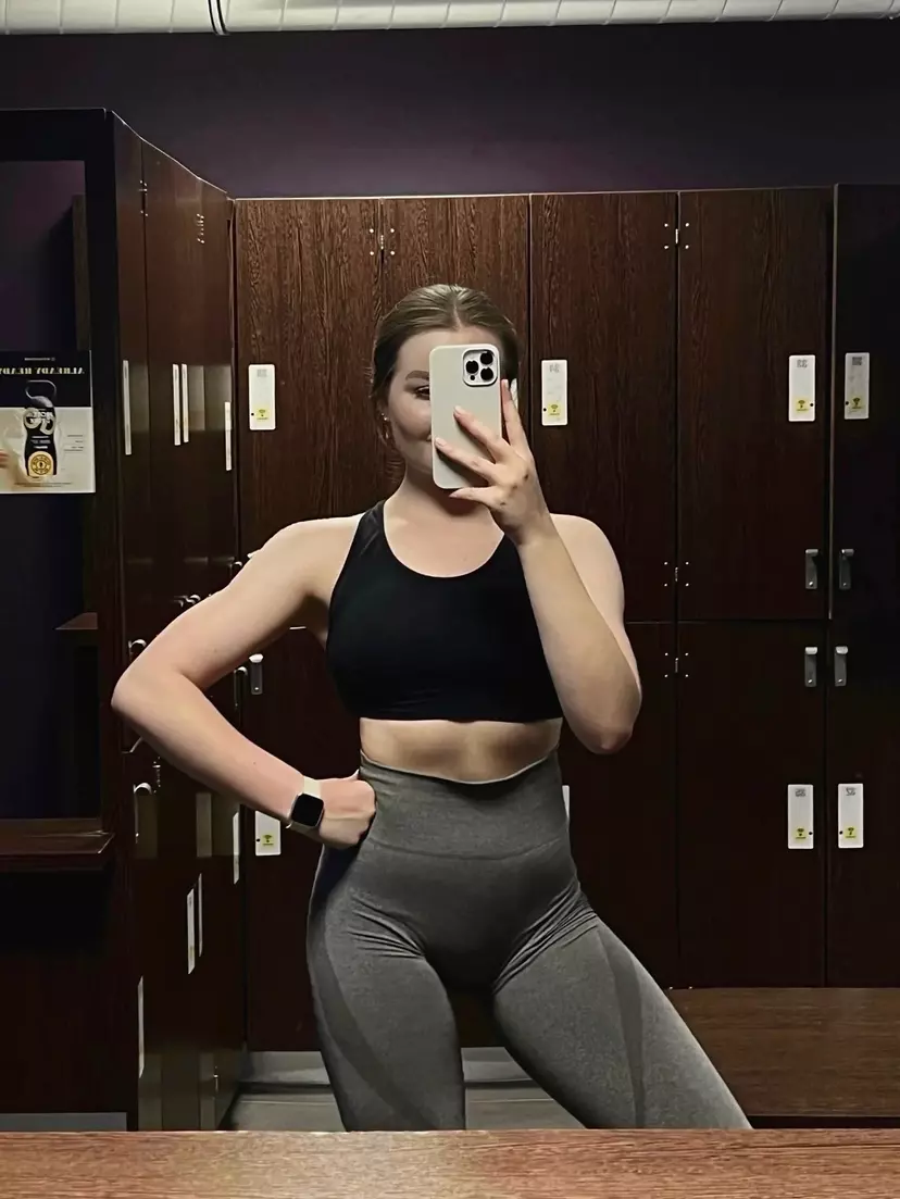 Beautiful young lady in gym clothes